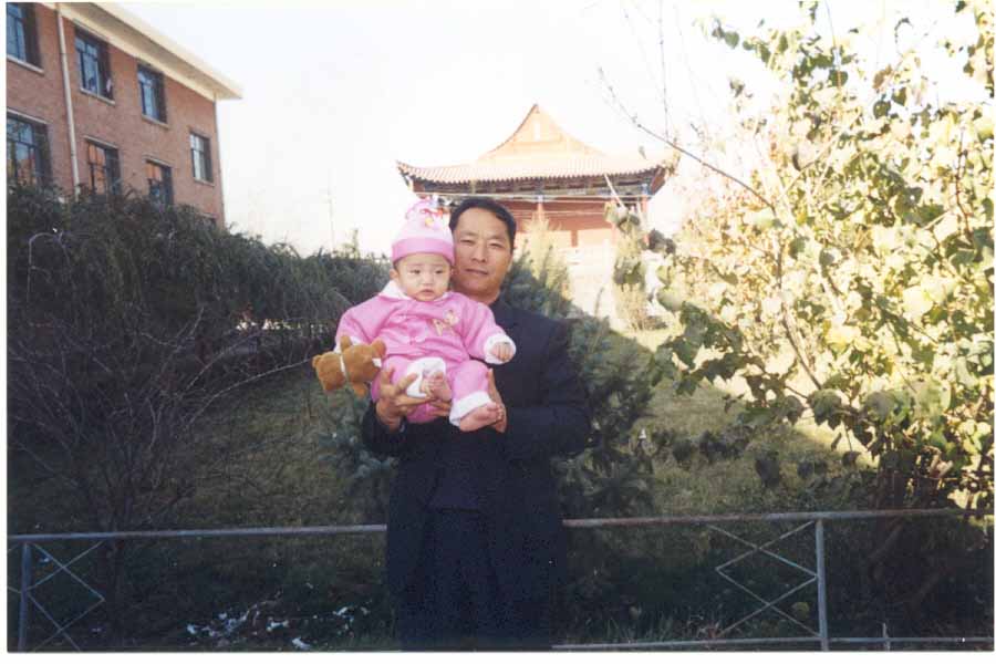 Wu Zhao outside with unidenfied staff